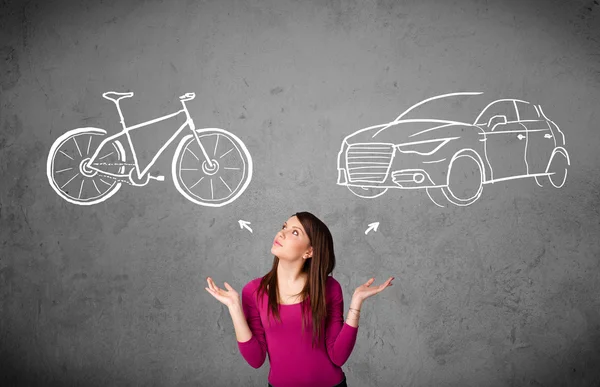 Woman making a choice between bicycle and car — Stock Photo, Image