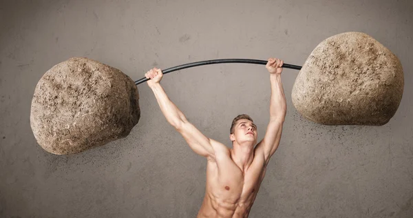 Muscular man lifting large rock stone weights — Stock Photo, Image