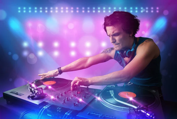 Disc jockey mixing music on turntables on stage with lights and — Stock Photo, Image