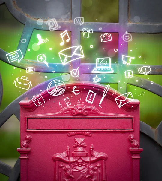 Farverige ikoner og symboler brister ud af en postkasse - Stock-foto
