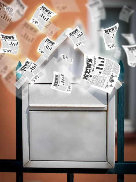 Post box with daily newspapers flying — Stock Photo, Image