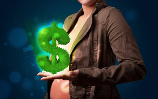 Young woman presenting green glowing dollar sign — Stock Photo, Image