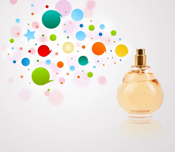 Perfume bottle spraying colored bubbles — Stock Photo, Image