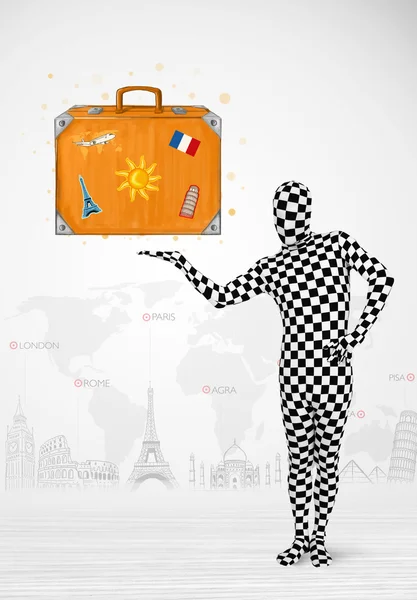 Man in full body suit presenting vacation suitcase — Stock Photo, Image