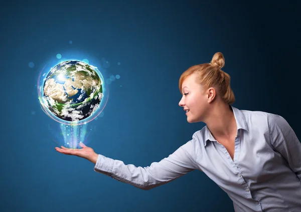 Businesswoman holding glowing earth globe — Stock Photo, Image