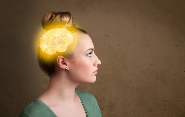 Young girl thinking with glowing brain illustration — Stock Photo, Image