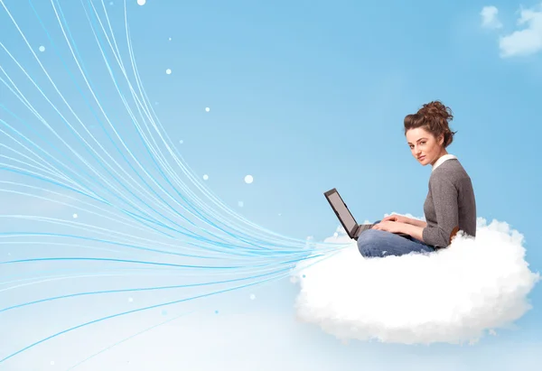 Young woman sitting in cloud with laptop — Stock Photo, Image