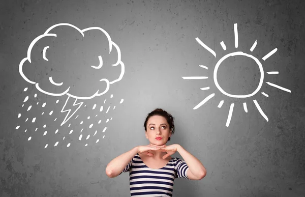 Woman standing between a sun and a rain drawing — Stock Photo, Image