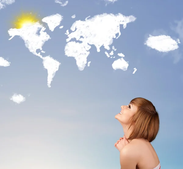 Young girl looking at world clouds and sun on blue sky — Stock Photo, Image