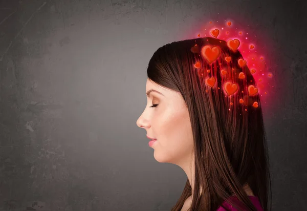 Young person thinking about love with red hearts — Stock Photo, Image