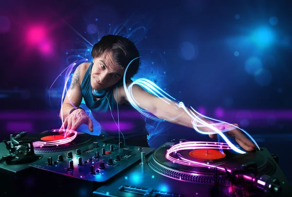 Disc jockey playing music with electro light effects and lights — Stock Photo, Image