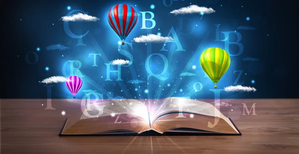 Open book with glowing fantasy abstract clouds and balloons — Stock Photo, Image