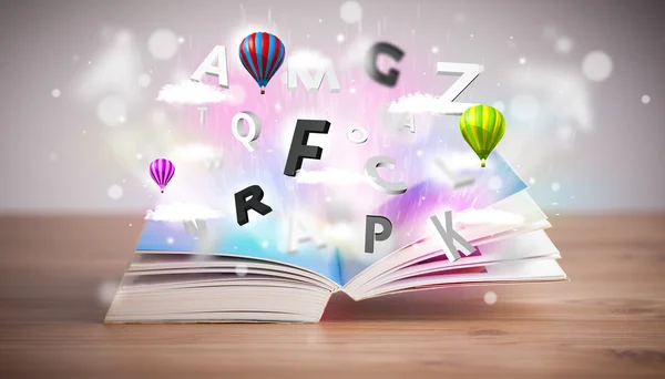 Livre ouvert avec des lettres 3D volantes sur fond concret — Photo