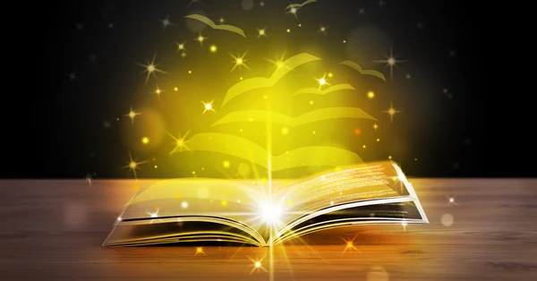 Open book with golden glow flying paper pages — Stock Photo, Image