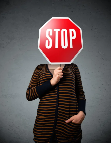 Young woman holding a stop sign — Stock Photo, Image