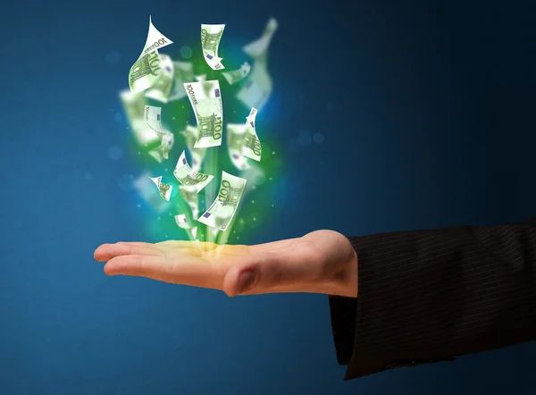 Glowing money in the hand of a businessman — Stock Photo, Image