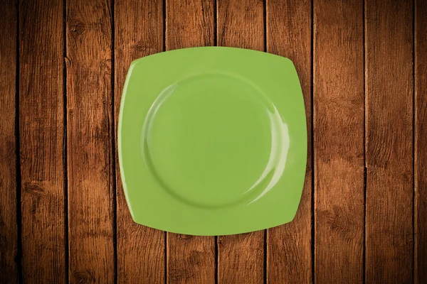 Placa vazia colorida na mesa de fundo grungy — Fotografia de Stock