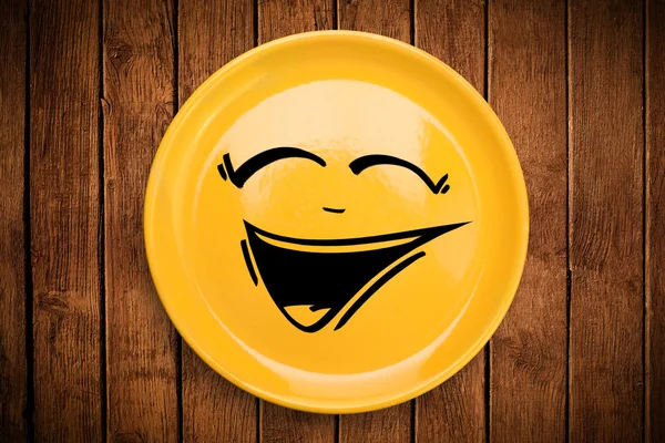 Happy smiley cartoon face on colorful dish plate — Stock Photo, Image