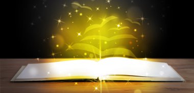 Altından parlak uçan kağıt sayfaları olan açık bir kitap