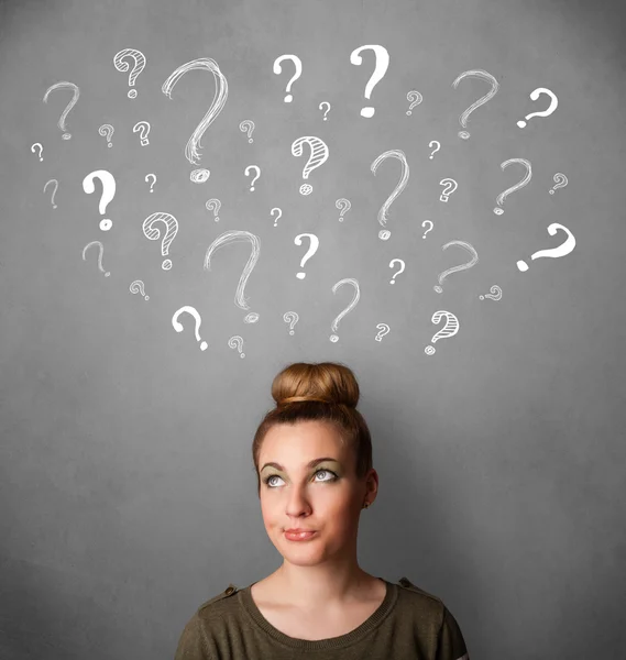 Young woman with question marks above her head — Stock Photo, Image