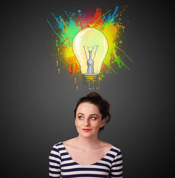 Young woman thinking with lightbulb above her head — Stock Photo, Image