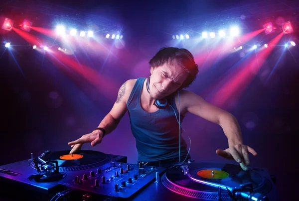 Teenager dj mixing records in front of a crowd on stage — Stock Photo, Image