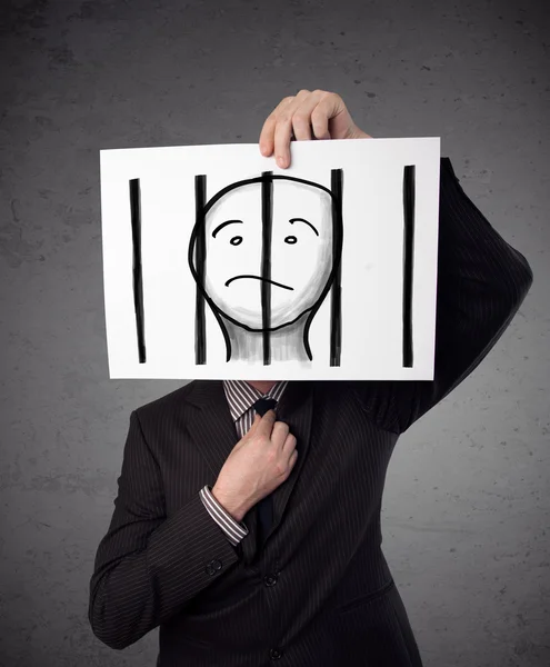 Businessman holding a paper with a prisoner behind the bars on i — Stock Photo, Image