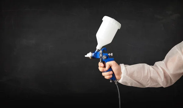 Painter works with airbrush gun and empty copyspace — Stock Photo, Image