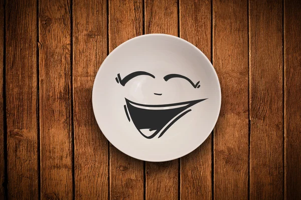 Happy smiley cartoon face on colorful dish plate — Stock Photo, Image