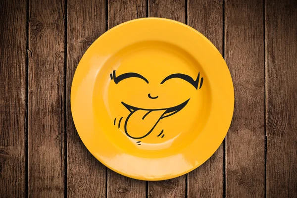 Happy smiley cartoon face on colorful dish plate — Stock Photo, Image