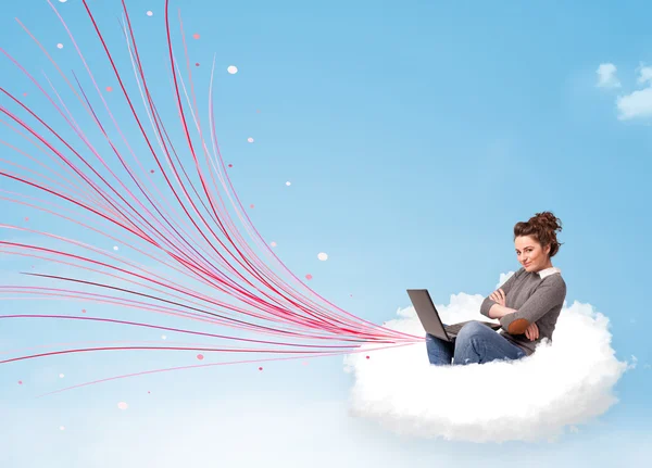 Young woman sitting in cloud with laptop — Stock Photo, Image