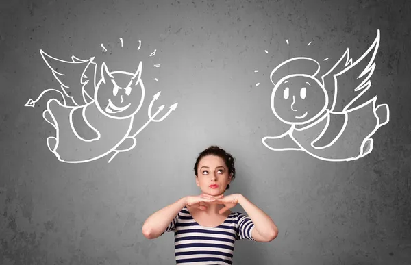 Woman standing between the angel and the devil — Stock Photo, Image