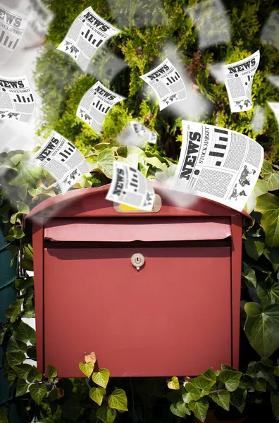 Post box with daily newspapers flying — Stock Photo, Image