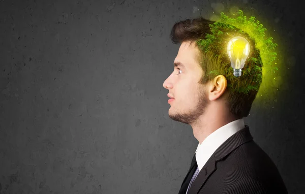 Young mind thinking of green eco energy with lightbulb — Stock Photo, Image