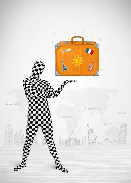 Man in full body suit presenting vacation suitcase — Stock Photo, Image