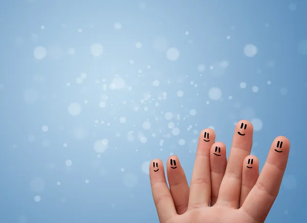 Happy finger smileys with empty blue bokeh background — Stock Photo, Image