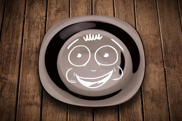 Happy smiley cartoon face on colorful dish plate — Stock Photo, Image