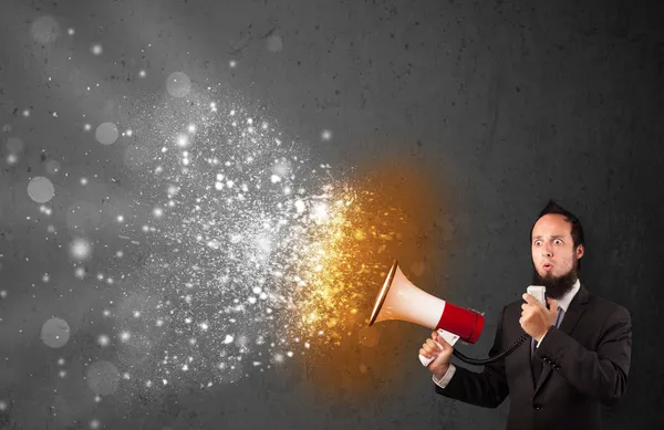 Guy shouting into megaphone and glowing energy particles explode — Stock Photo, Image