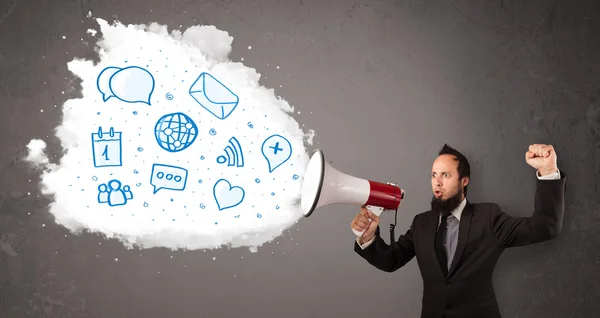 Man shouting into loudspeaker and modern blue icons and symbols — Stock Photo, Image