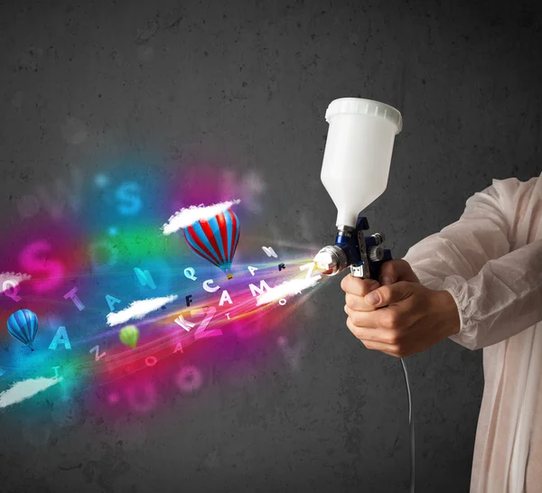 Worker with airbrush and colorful abstract clouds and balloons — Stock Image Worker with airbrush and colorful abstract clouds and balloons Stock Picture