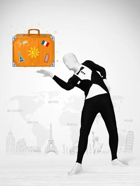 Man in full body suit presenting vacation suitcase — Stock Photo, Image