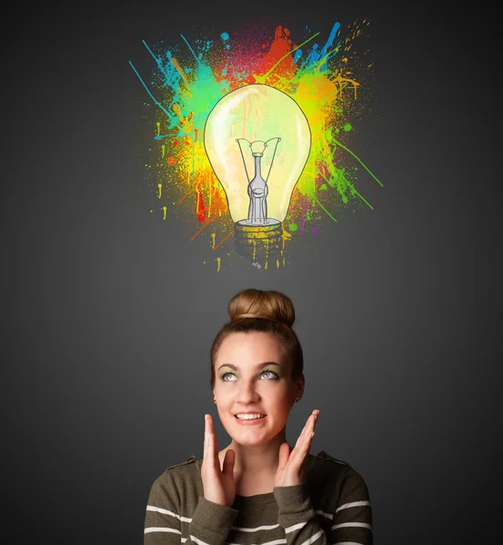 Young woman thinking with lightbulb above her head — Stock Photo, Image