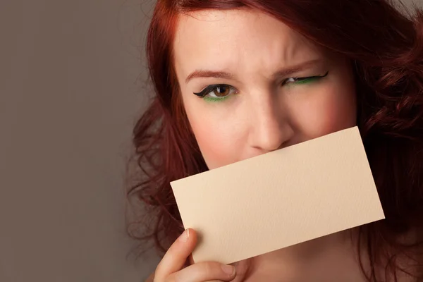 Cute girl holding white card at front of her lips with copy spac — Stock Photo, Image