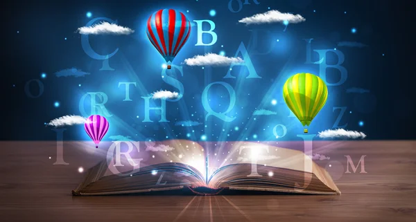 Open book with glowing fantasy abstract clouds and balloons — Stock Photo, Image