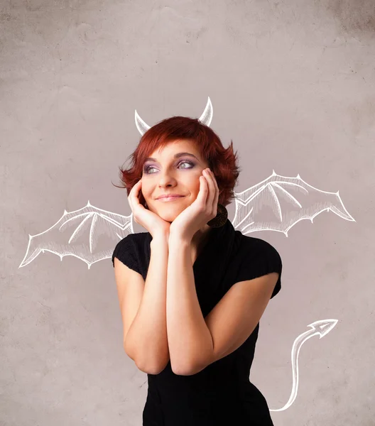 Young girl with devil horns and wings drawing — Stock Photo, Image