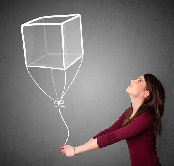 Vrouw met een kubus ballon — Stockfoto