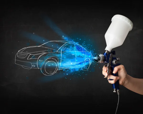 Worker with airbrush gun painting hand drawn car lines — Stock Photo, Image