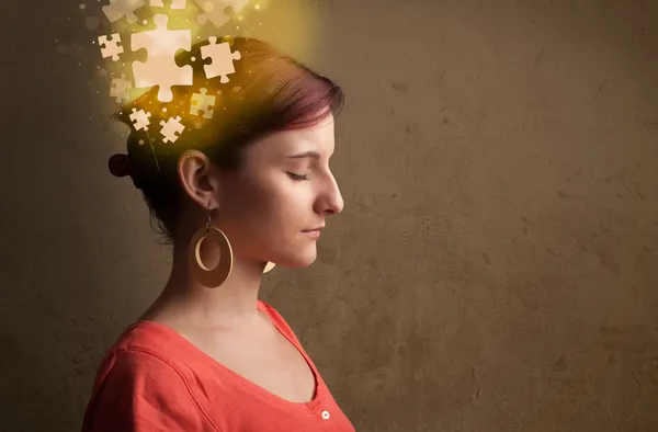 Young person thinking with glowing puzzle mind — Stock Photo, Image