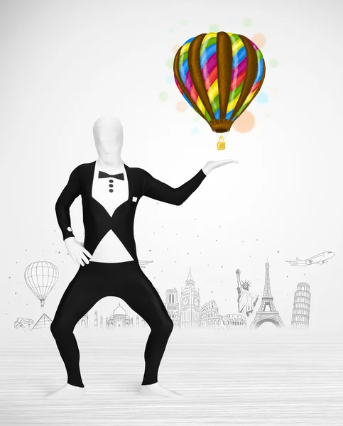 Man in full body suit holding balloon — Stock Photo, Image