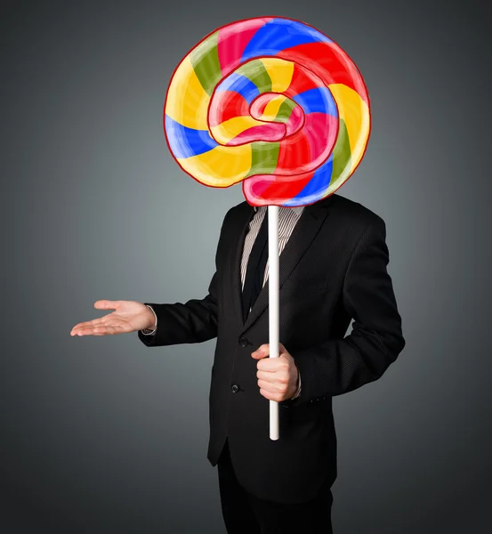 Businessman holding a lollipop — Stock Photo, Image